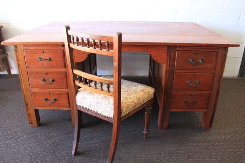 A magnificent large solid oak partners desk with loads of drawer space and ornate handles
