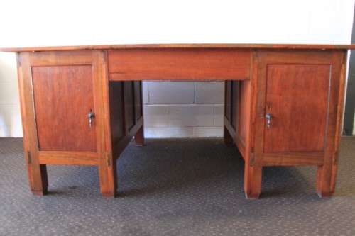 A magnificent large solid oak partners desk with loads of drawer space and ornate handles