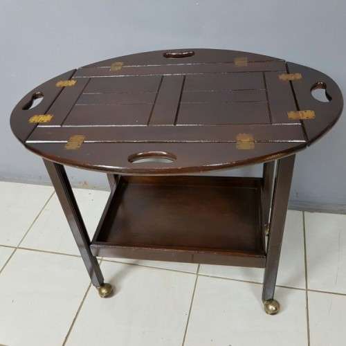 An exquisite Teak "Butlers" trolley on castors with brass hinges; Opens into a removable oval table