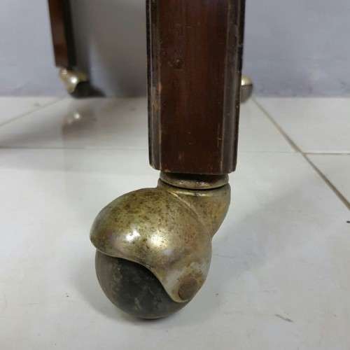 An exquisite Teak "Butlers" trolley on castors with brass hinges; Opens into a removable oval table
