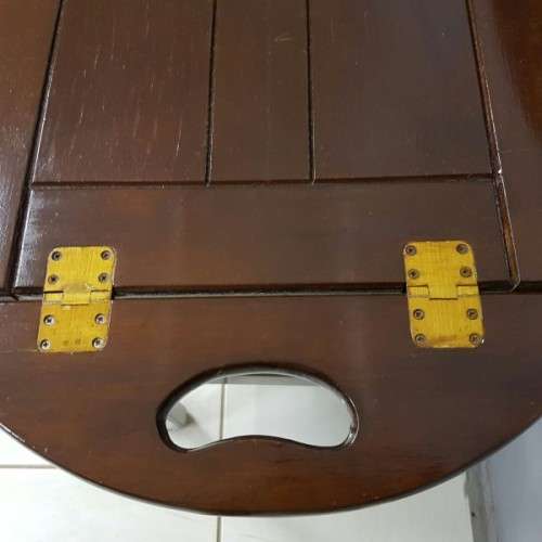 An exquisite Teak "Butlers" trolley on castors with brass hinges; Opens into a removable oval table