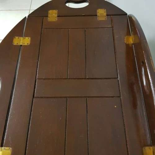 An exquisite Teak "Butlers" trolley on castors with brass hinges; Opens into a removable oval table