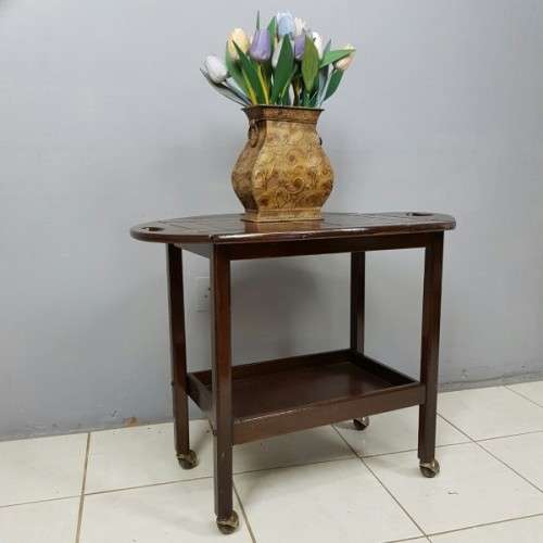 An exquisite Teak "Butlers" trolley on castors with brass hinges; Opens into a removable oval table
