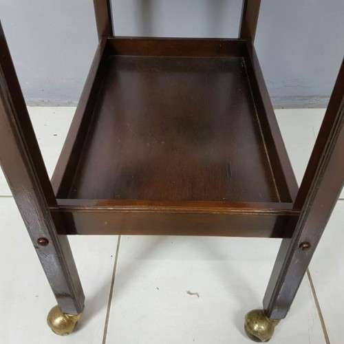 An exquisite Teak "Butlers" trolley on castors with brass hinges; Opens into a removable oval table
