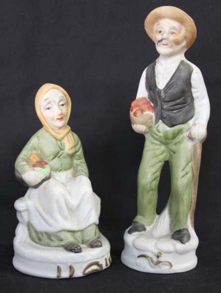 Two wonderful ceramic figurines of an a farmer and his wife with hand painted detailing bid/figurine