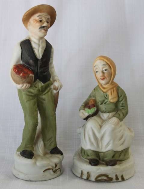 Two wonderful ceramic figurines of an a farmer and his wife with hand painted detailing bid/figurine