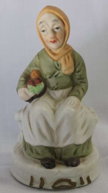 Two wonderful ceramic figurines of an a farmer and his wife with hand painted detailing bid/figurine