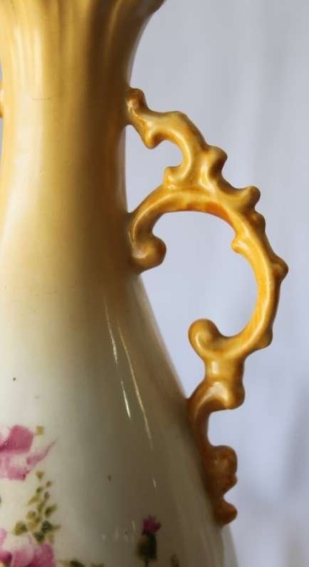 A gorgeous tall German-porcelain vase with scroll handles, flared rim and transfer print flowers