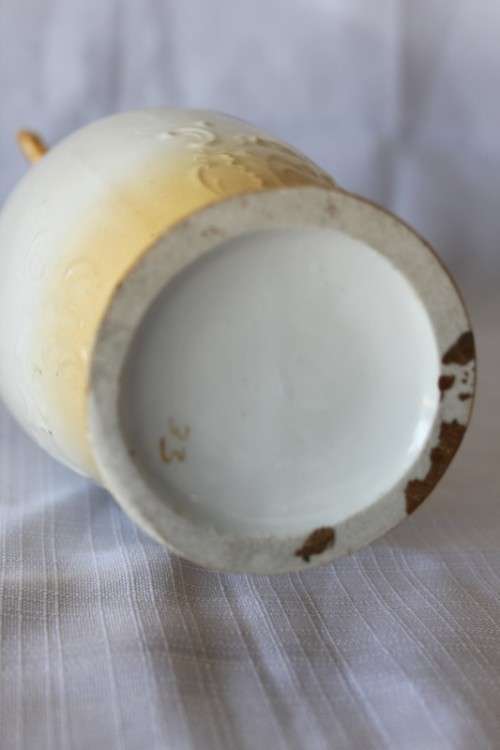 A gorgeous tall German-porcelain vase with scroll handles, flared rim and transfer print flowers