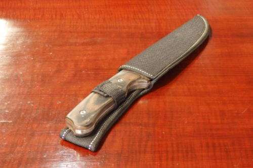 An amazing "full tang" hunting knife with knife sheath and belt slot in near mint condition