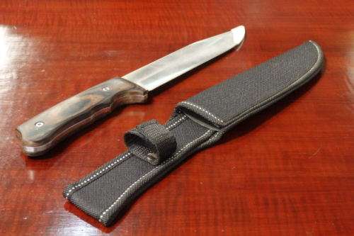An amazing "full tang" hunting knife with knife sheath and belt slot in near mint condition