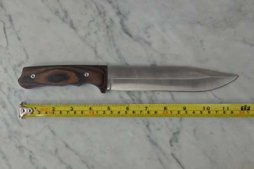 An amazing "full tang" hunting knife with knife sheath and belt slot in near mint condition