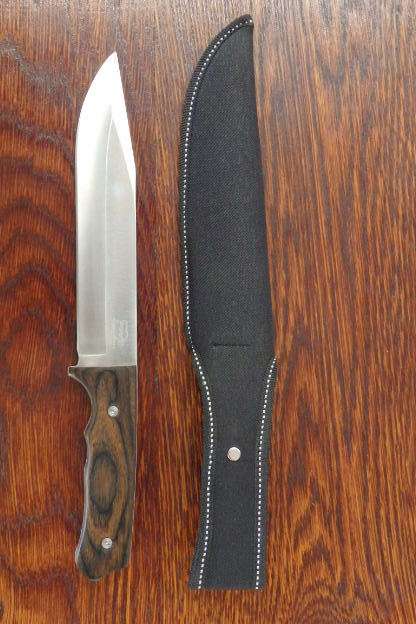 An amazing "full tang" hunting knife with knife sheath and belt slot in near mint condition