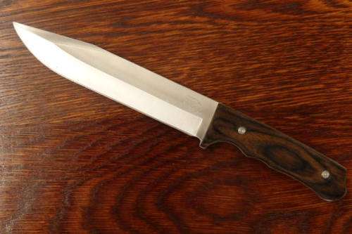 An amazing "full tang" hunting knife with knife sheath and belt slot in near mint condition