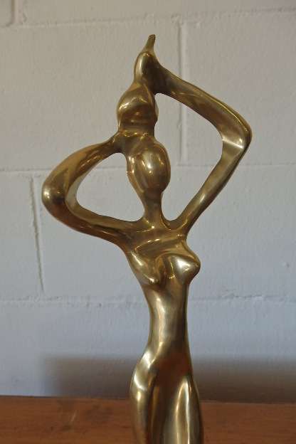 An incredible (tall) solid brass abstract figurine on a wooden stand in stunning condition