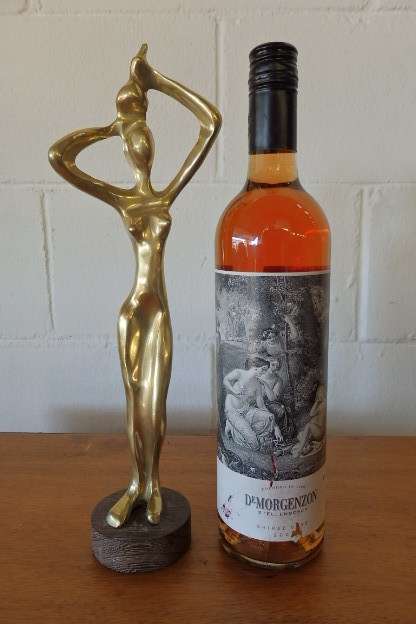 An incredible (tall) solid brass abstract figurine on a wooden stand in stunning condition