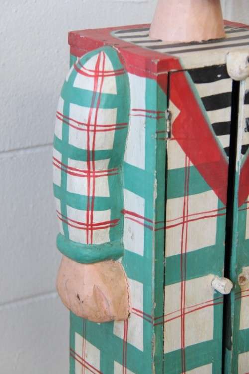 An interesting and unusual free standing antique tabletop cabinet in the form of a clown w/ shelves