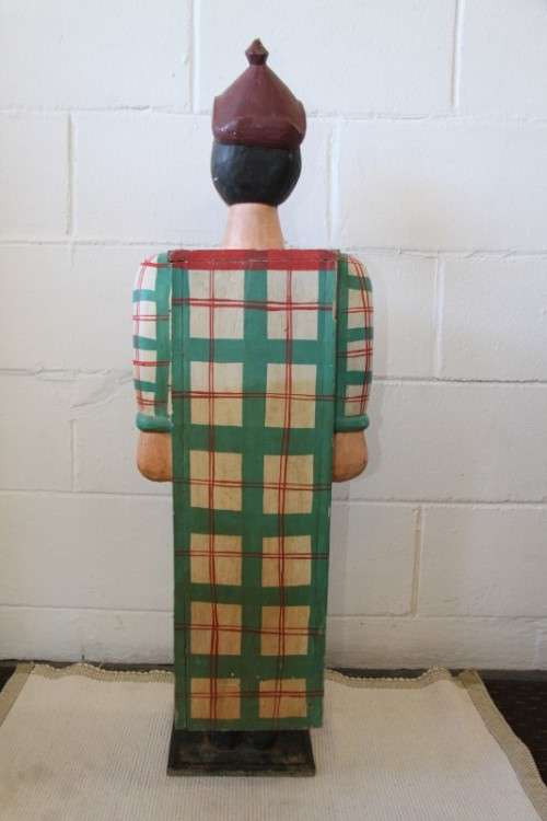 An interesting and unusual free standing antique tabletop cabinet in the form of a clown w/ shelves