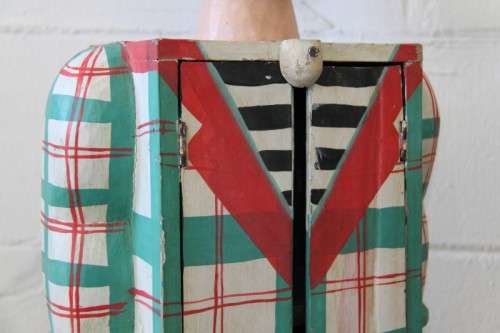 An interesting and unusual free standing antique tabletop cabinet in the form of a clown w/ shelves