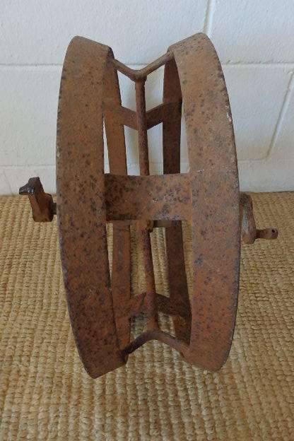 An awesome antique cast iron double-rimmed six-spoke Plough Wheel, perfect for any garden decor