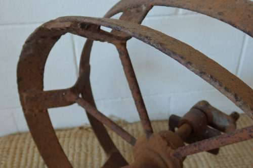 An awesome antique cast iron double-rimmed six-spoke Plough Wheel, perfect for any garden decor