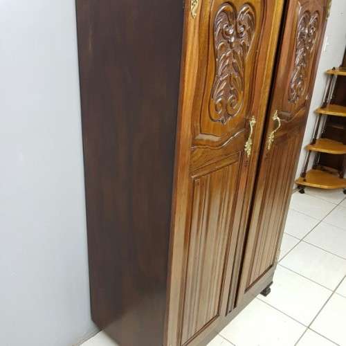 A stunning carved double-door solid Imbuia wardrobe with solid brass embellishments & ample space