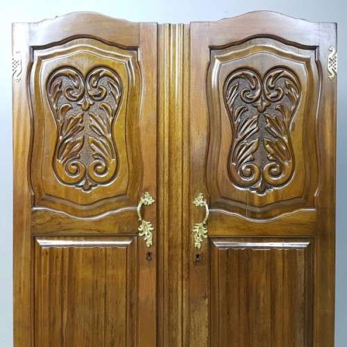 A stunning carved double-door solid Imbuia wardrobe with solid brass embellishments & ample space