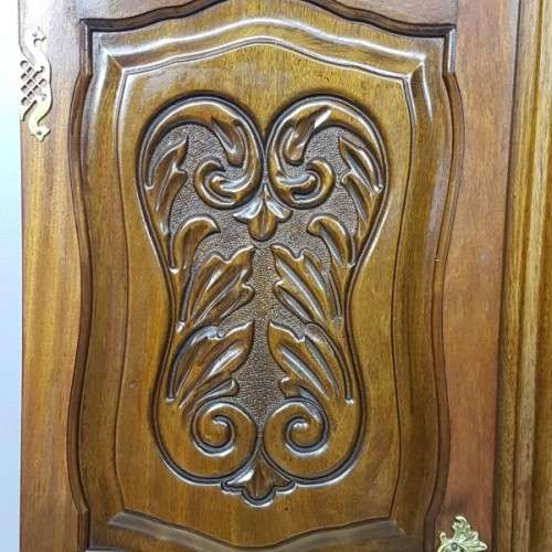 A stunning carved double-door solid Imbuia wardrobe with solid brass embellishments & ample space