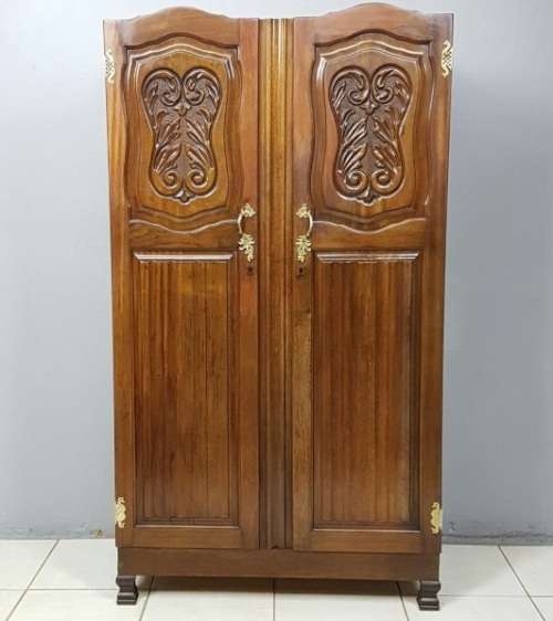 A stunning carved double-door solid Imbuia wardrobe with solid brass embellishments & ample space