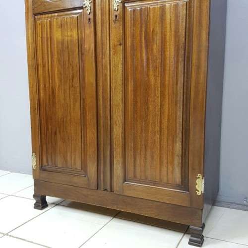 A stunning carved double-door solid Imbuia wardrobe with solid brass embellishments & ample space