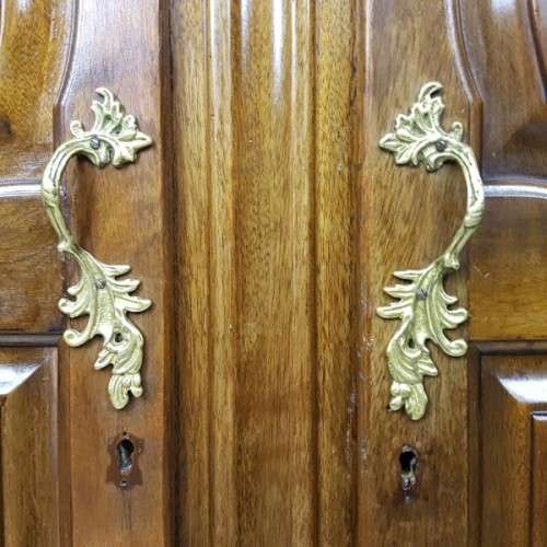 A stunning carved double-door solid Imbuia wardrobe with solid brass embellishments & ample space