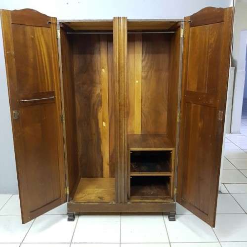 A stunning carved double-door solid Imbuia wardrobe with solid brass embellishments & ample space