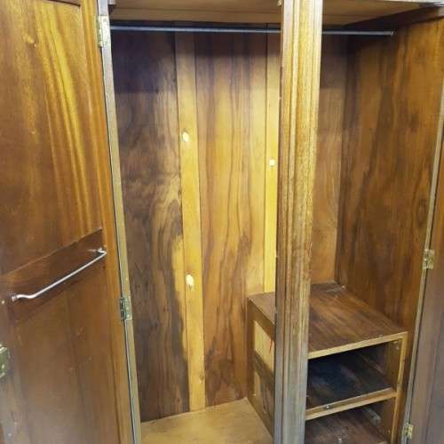 A stunning carved double-door solid Imbuia wardrobe with solid brass embellishments & ample space