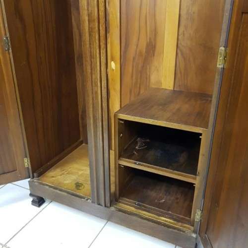 A stunning carved double-door solid Imbuia wardrobe with solid brass embellishments & ample space