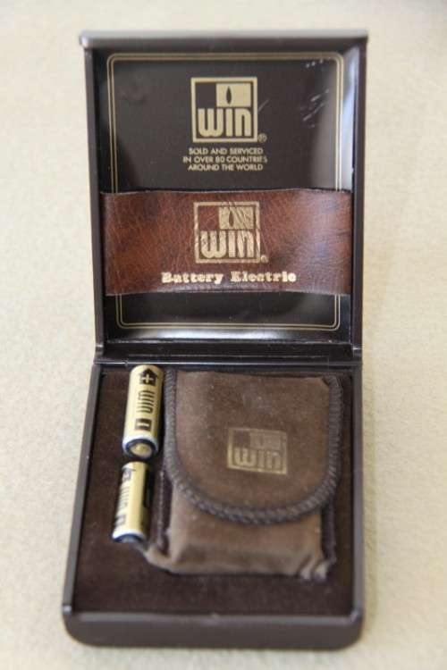 A superb original "Win Battery Electric" cigarette lighter with pouch in its original case
