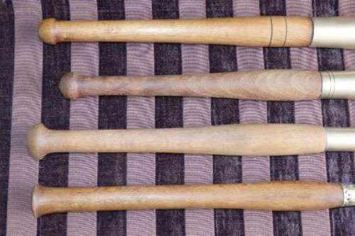 An incredible set of four vintage sculpting tools with wooden handles, brass cuffs & celluloid tips