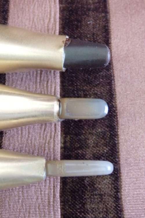 An incredible set of four vintage sculpting tools with wooden handles, brass cuffs & celluloid tips