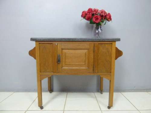 A spectacular vintage Oak wash stand with a solid black marble top & spacious cupboard on castors