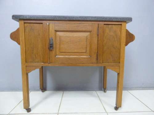 A spectacular vintage Oak wash stand with a solid black marble top & spacious cupboard on castors