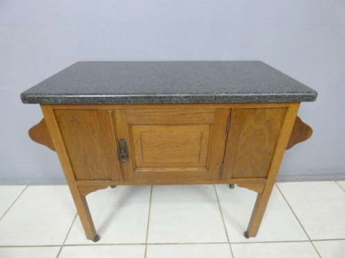 A spectacular vintage Oak wash stand with a solid black marble top & spacious cupboard on castors