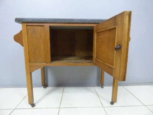 A spectacular vintage Oak wash stand with a solid black marble top & spacious cupboard on castors
