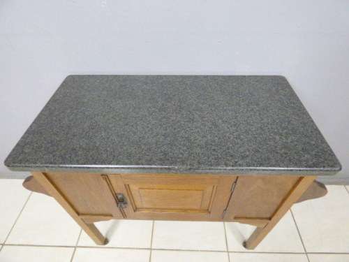 A spectacular vintage Oak wash stand with a solid black marble top & spacious cupboard on castors