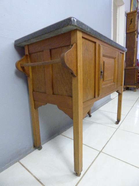 A spectacular vintage Oak wash stand with a solid black marble top & spacious cupboard on castors