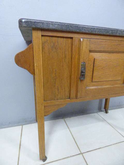 A spectacular vintage Oak wash stand with a solid black marble top & spacious cupboard on castors