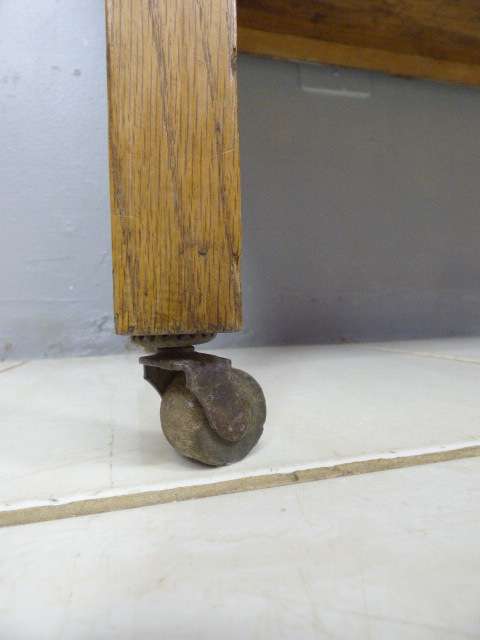 A spectacular vintage Oak wash stand with a solid black marble top & spacious cupboard on castors