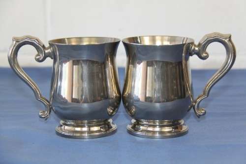 An awesome pair of silver plated mugs with ornate handles in stunning condition