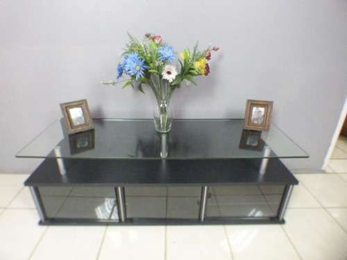 A stunning stylish TV stand with place for your entertainment centre and a thick glass top RS17