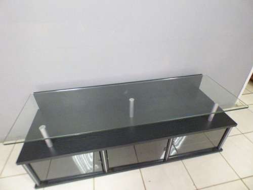 A stunning stylish TV stand with place for your entertainment centre and a thick glass top RS17