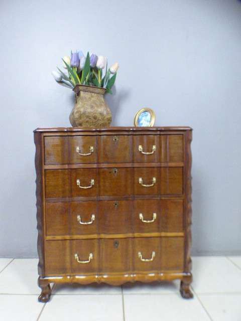 An exquisite vintage Imbuia 4-drawer chest of drawers with ornate handles and ample storage space