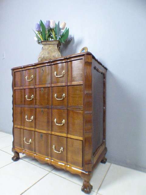 An exquisite vintage Imbuia 4-drawer chest of drawers with ornate handles and ample storage space